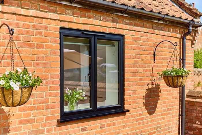 Black aluminium casement window at back of house