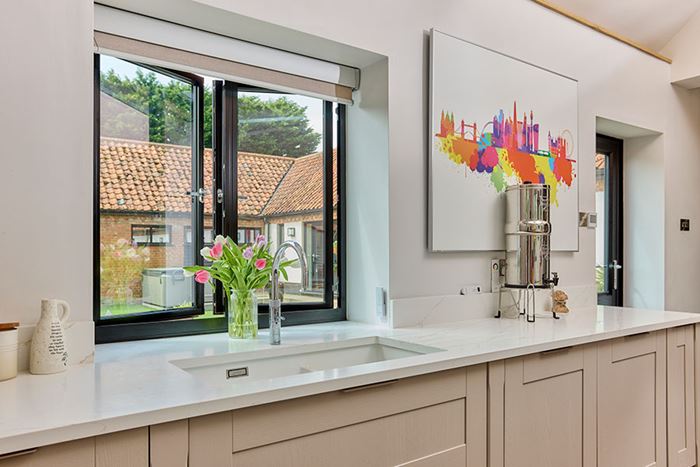 Black aluminium casement window in kitchen open