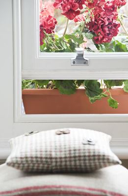 Close up of open White wooden sash window with chrome sash window pull from the Anglian sash window range