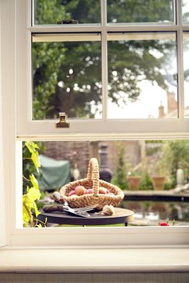 Close up of traditional wooden sash window with cottage bars finished in White from the Anglian sliding sash range