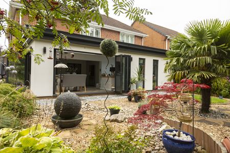 CosyRoom Extension with black aluminium Bifold doors & black uPVC Windows