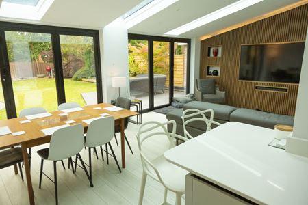CosyRoom Extension with two sets of black aluminium Bifold doors