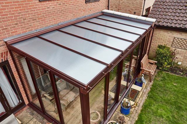 Dark woodgrain lean to with polycarbonate roof