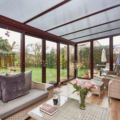 Dark woodgrain uPVC lean to conservatory with polycarbonate roof