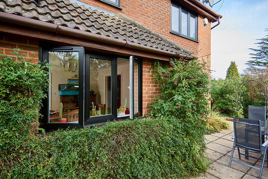 Dual Black ash uPVC flush window at back of house