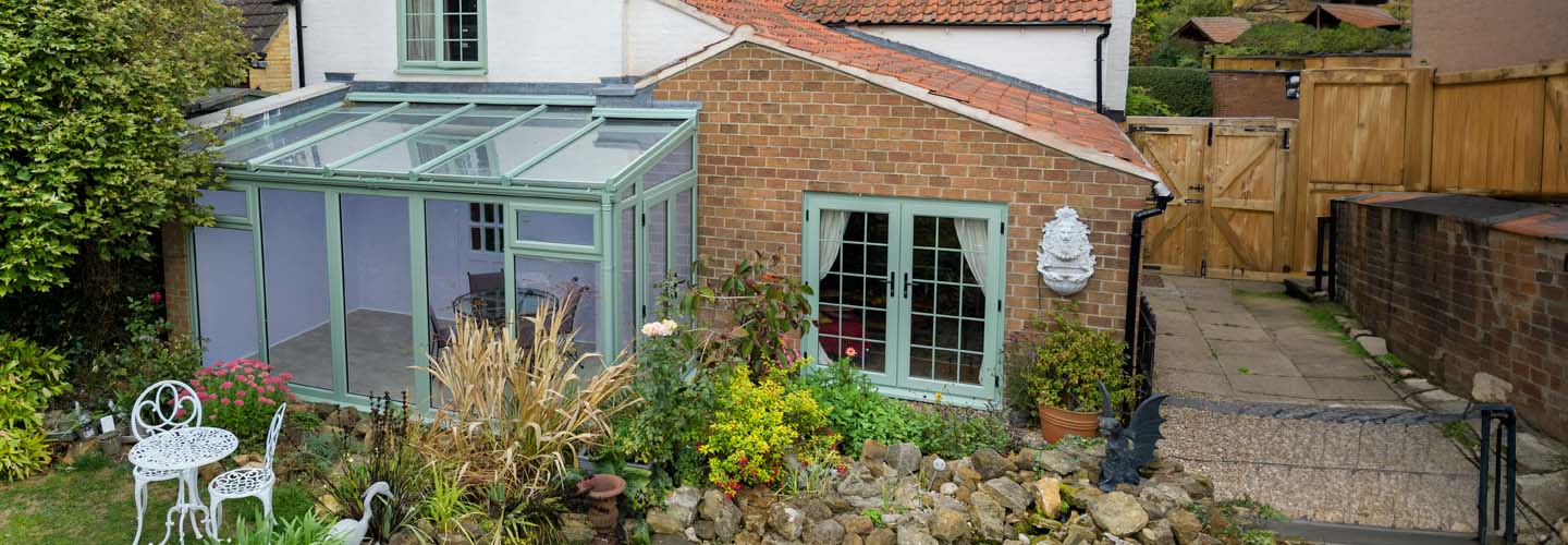 Dual sage green uPVC lean to garden room