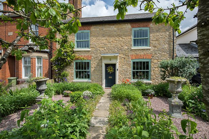 Dual sage green uPVC sash windows front of house