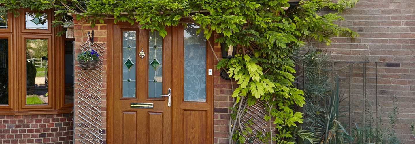 Golden oak uPVC front door with stained and etched glasss banner