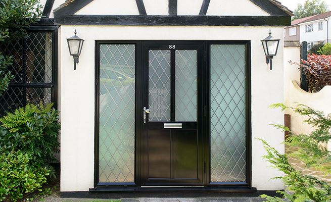 Black aluminium traditional front door in Erlestoke design with leaded glass and side panels