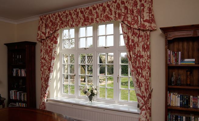 White double glazed UPVC dining room window with cottage bars from the Anglian double glazing window range