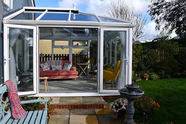 Small conservatory with French doors and solar roof