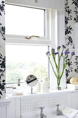 Close up of top hung White UPVC casement bathroom window with gold window handle from Anglian Home Improvements