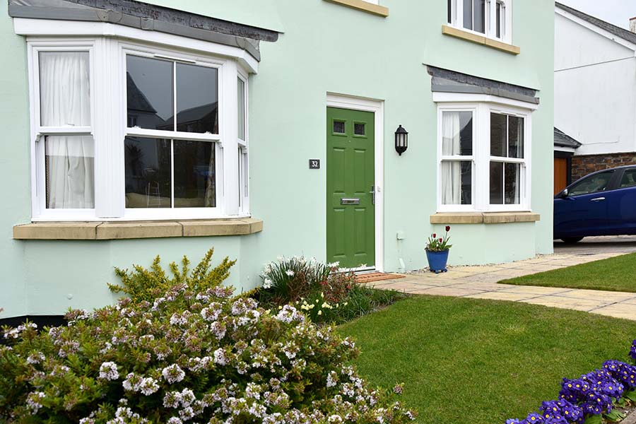 White bay windows with green front door