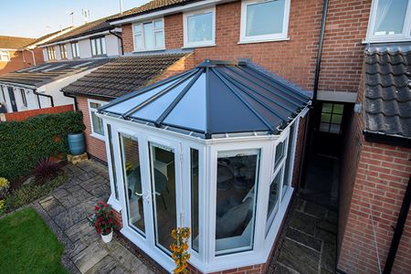 White stretched victorian conservatory with solid panel roof