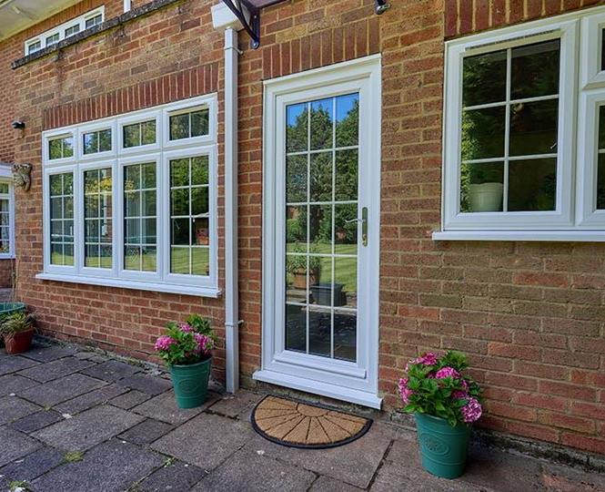 White uPVC back door with white windows with georgian bars
