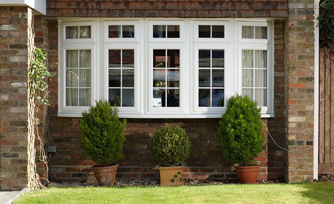 Exterior view of White UPVC bay window with Georgian bars from the Anglian bay window range