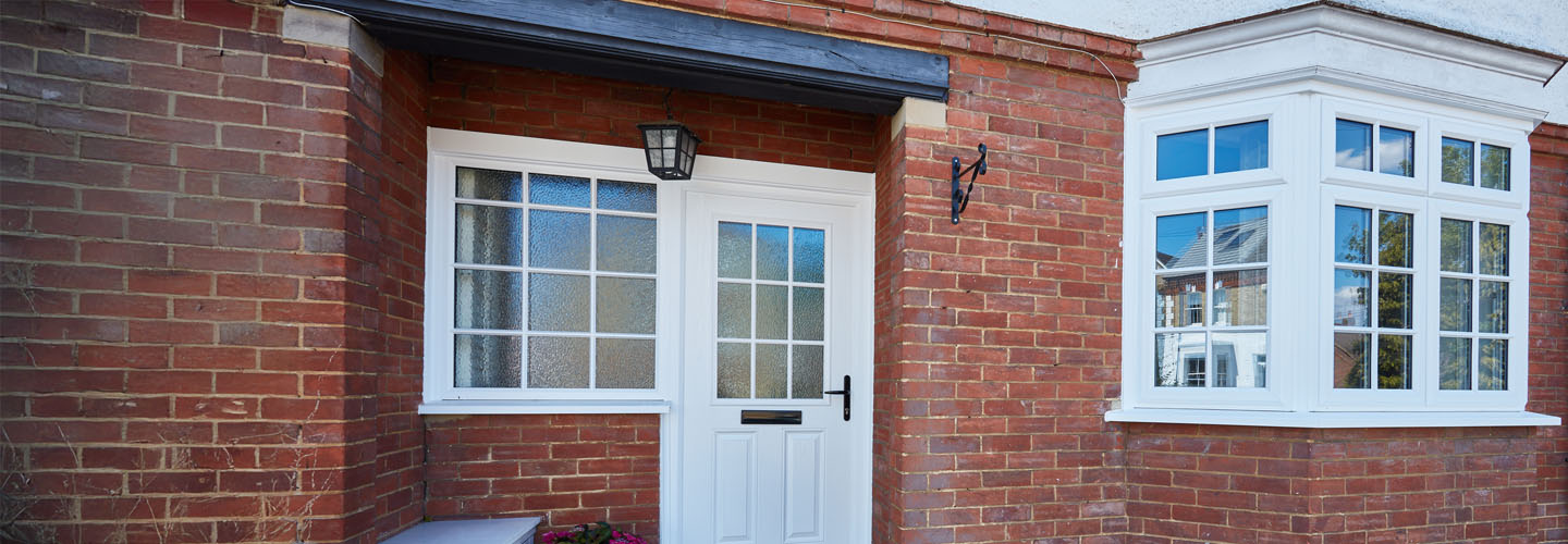 White uPVC casement window with cottage bar and Lincoln front door in white whole house banner