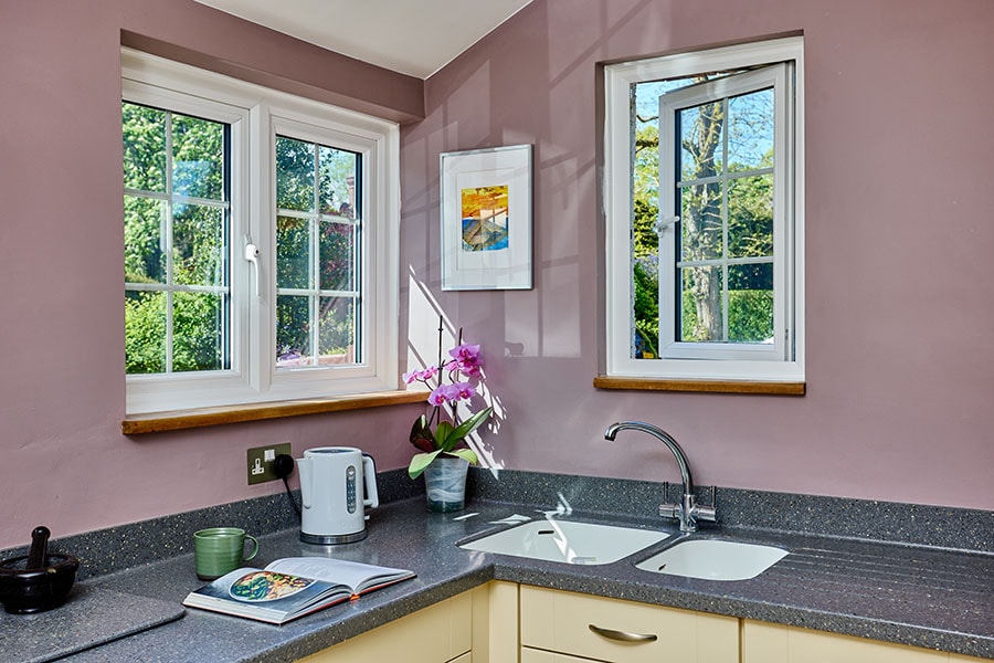 White uPVC casement windows in terracotta kitchen