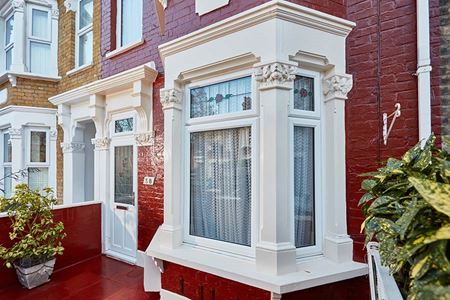 White uPVC casment window with Rose stained glass panel
