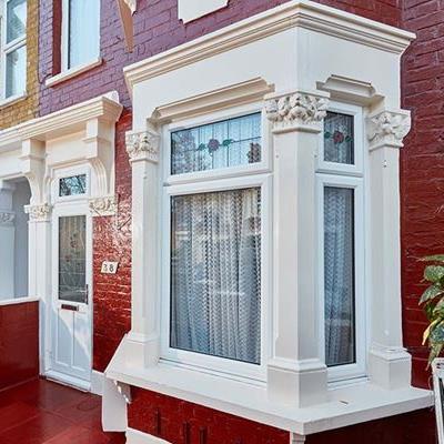 White uPVC casment window with Rose stained glass panel