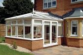 White Knight classic UPVC conservatory with top hung casement windows and French doors finished with traditional finials