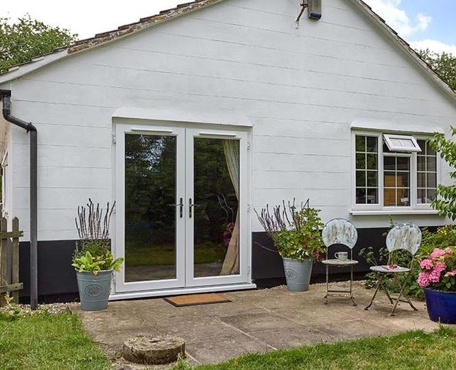 White uPVC French doors with with windows with Georgian bars