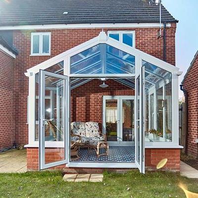 White uPVC regency conservatory with French doors in open position