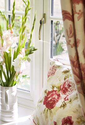 Close up of White UPVC casement window with cottage bars and gold window handle from Anglian Home Improvements