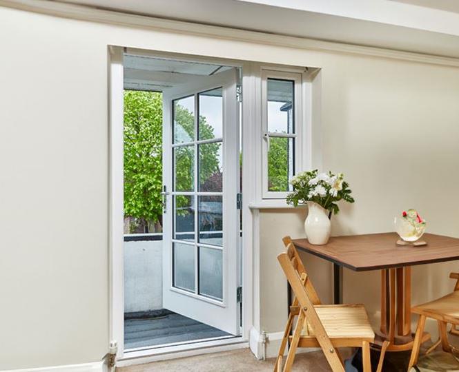 White wooden back door with Georgian Bars
