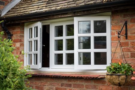 White wooden flush window with cottage bars