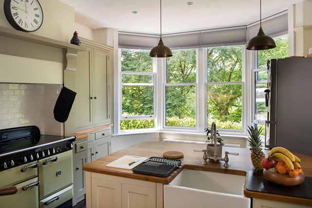 White wooden sliding spiral sash windows in kitchen interior