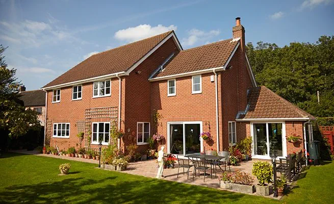 Back of house view of White uPVC guttering downpipes and soffits and fasica from Anglian Home Improvements
