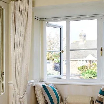 Double glazed White UPVC casement window with cottage bar inserts and gold window handles from Anglian Home Improvements